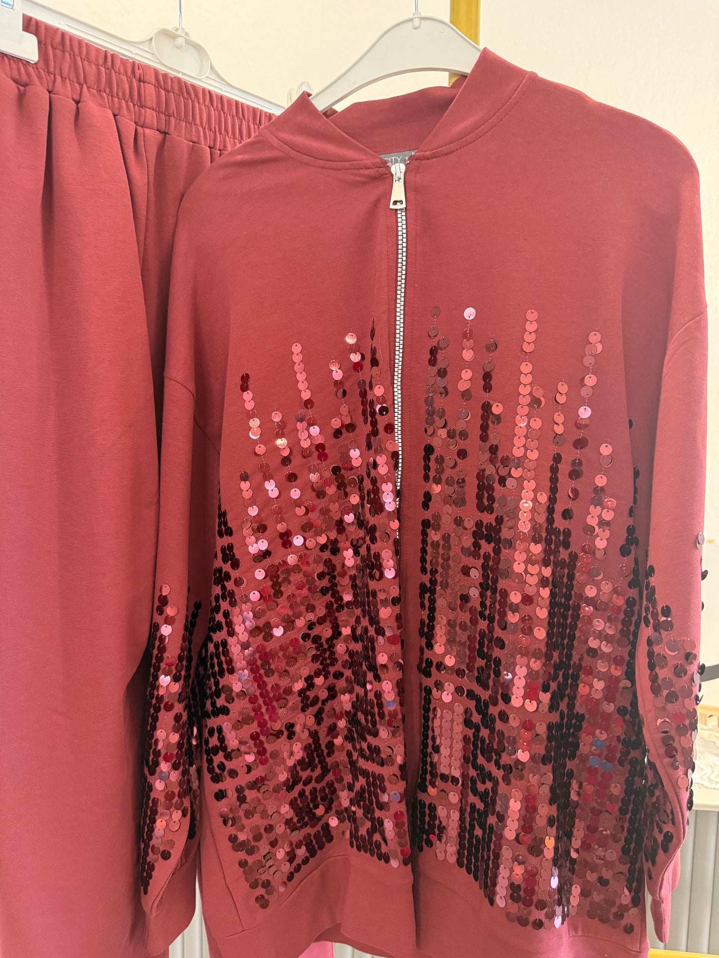 Two-piece sequin tracksuit.