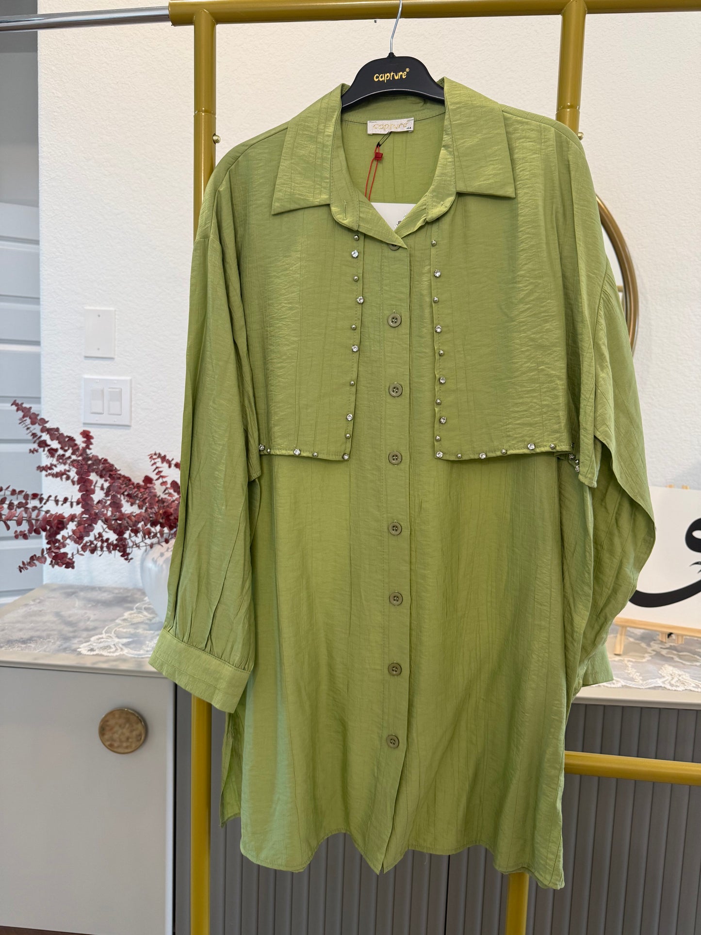 A longline button-down tunic shirt in a fresh green shade with stylish stud detailing.