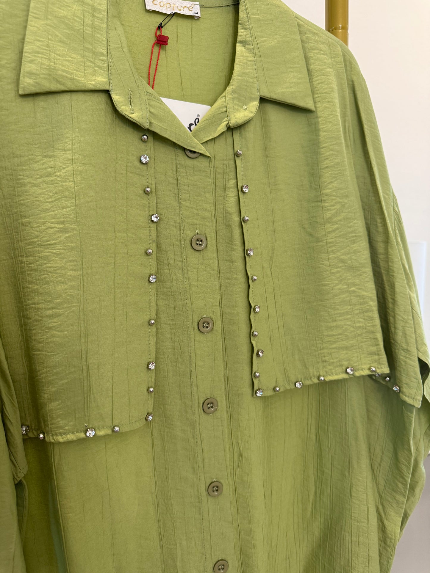 A longline button-down tunic shirt in a fresh green shade with stylish stud detailing.
