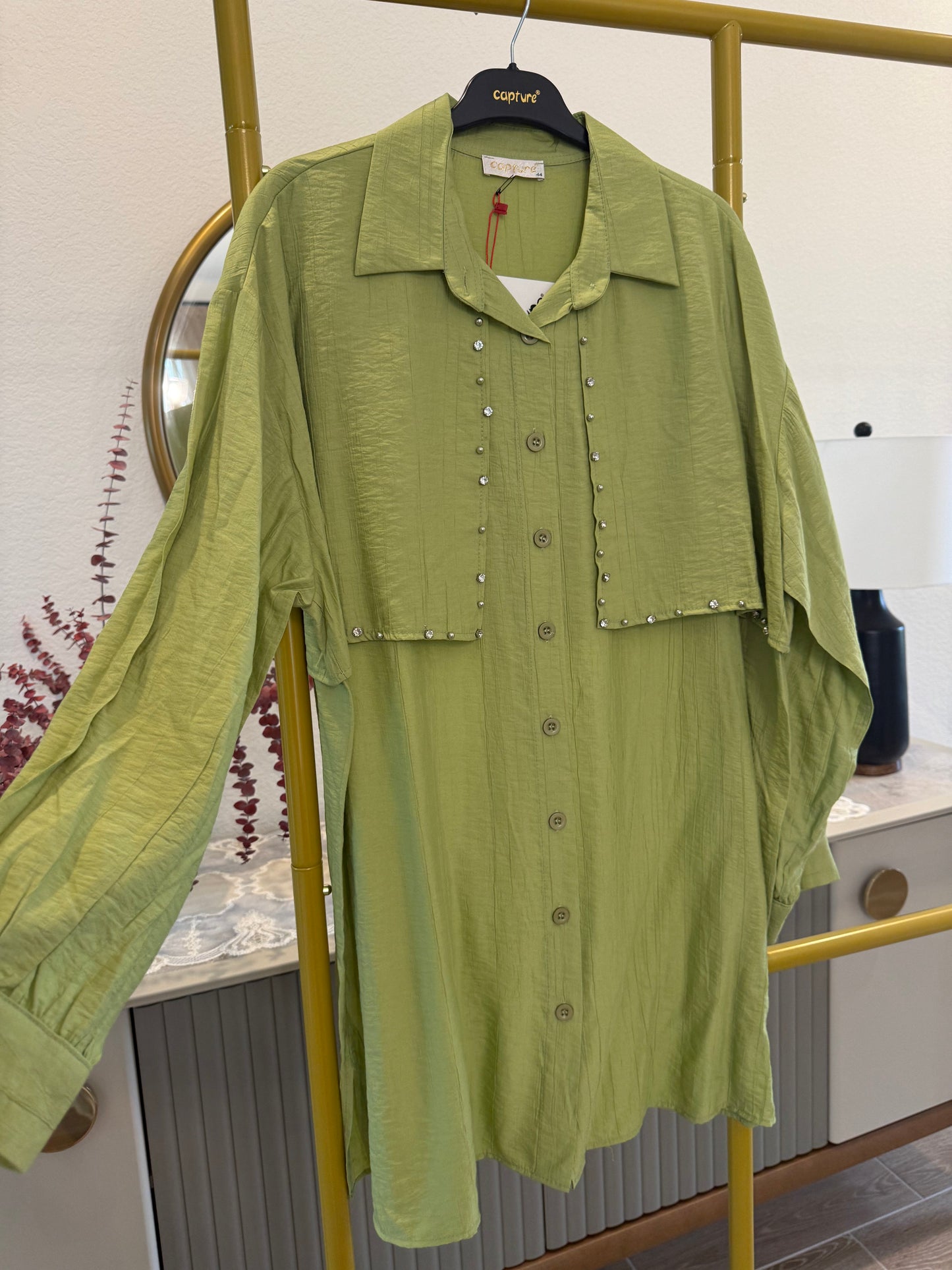 A longline button-down tunic shirt in a fresh green shade with stylish stud detailing.