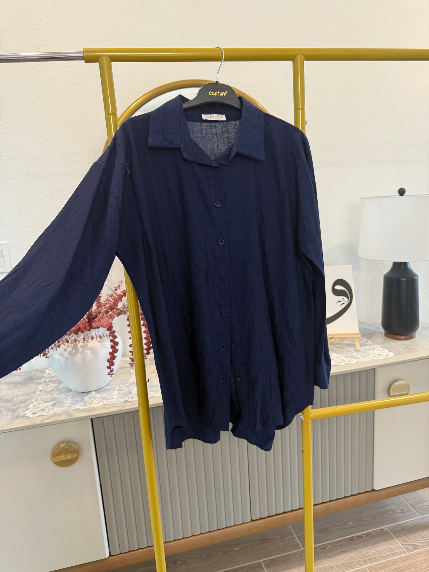 A classic longline button-down shirt in deep navy blue