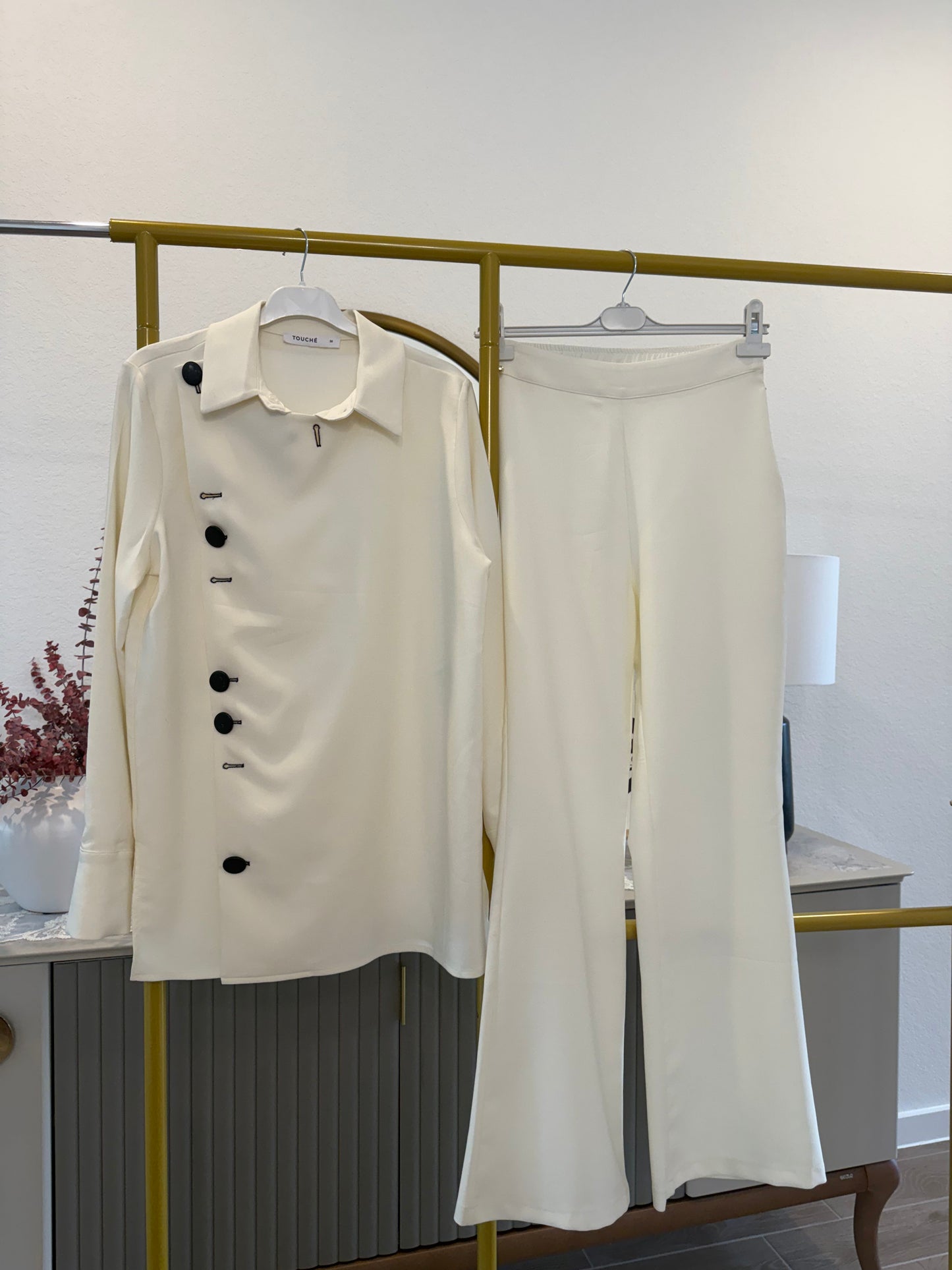 A two-piece cream pants set (Touche brand)
