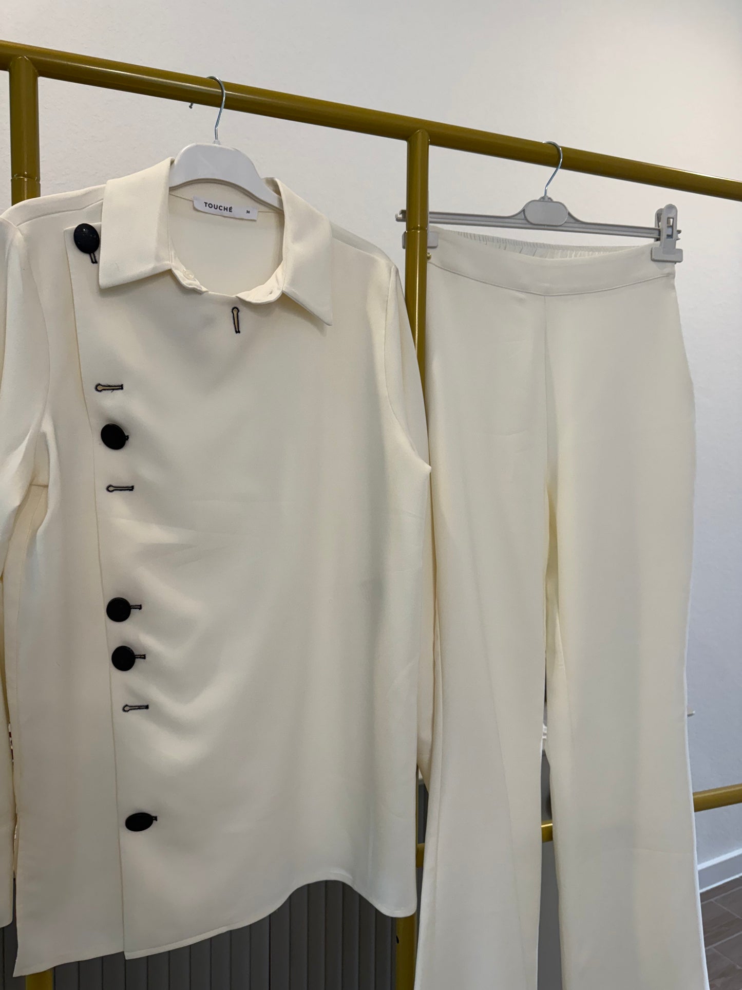 A two-piece cream pants set (Touche brand)