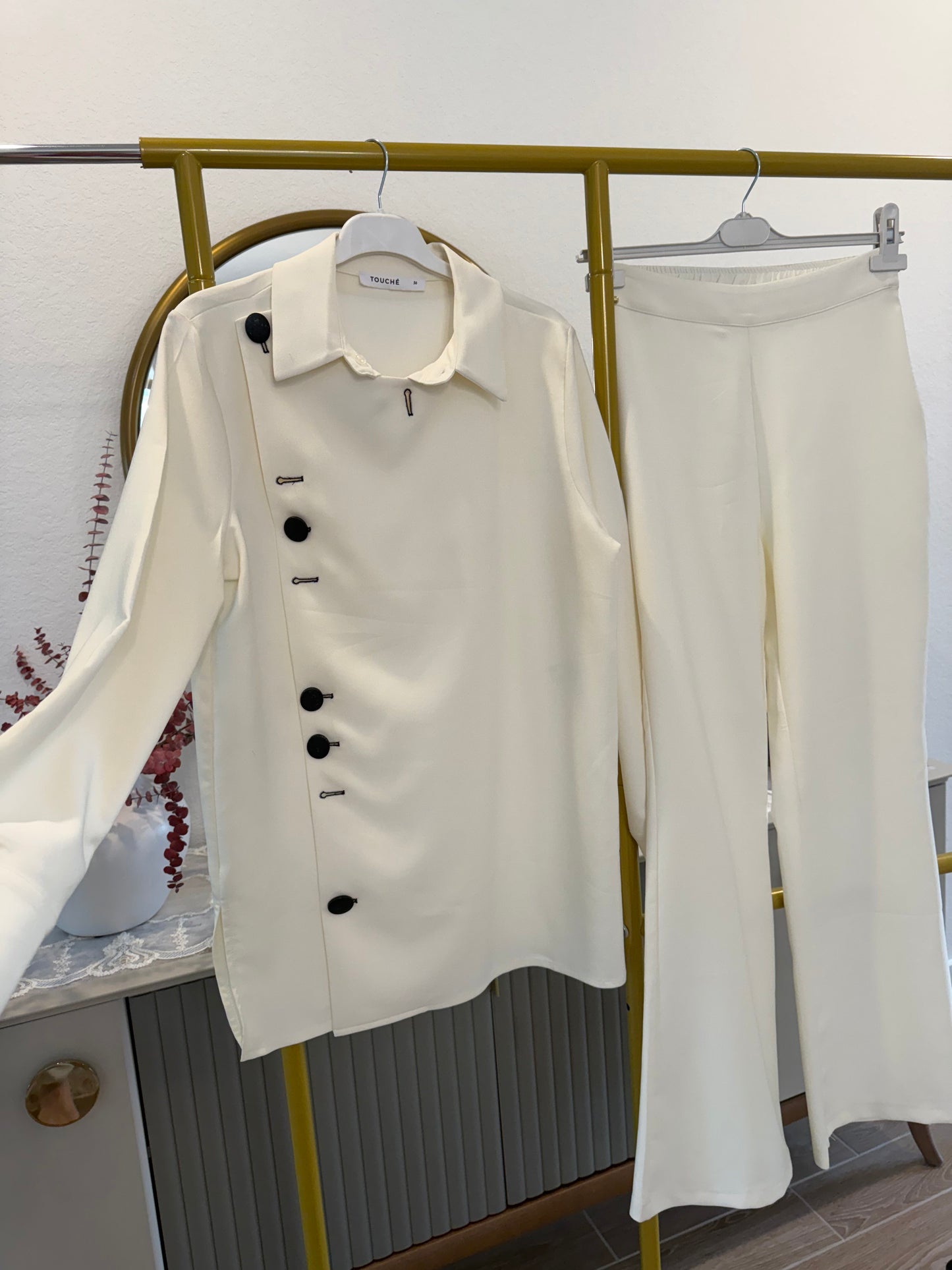 A two-piece cream pants set (Touche brand)